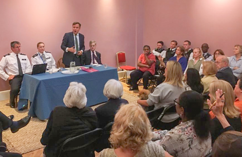 Greg Hands addressing a recent public meeting on crime in Chelsea